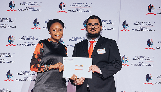 Mr Yaser Alli receives his award from Dr Normah Zondo, Executive Director: Corporate Relations Division.